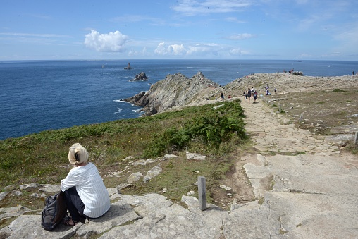 Tourist at the Pointe du Raz and lighthouse of the Old in Brittany