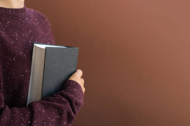 istock Woman student with books on brown 1267160602
