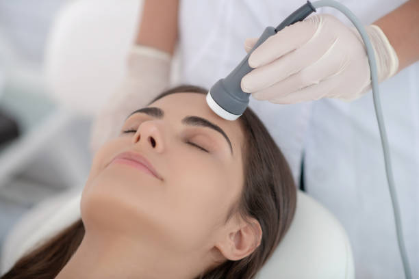 istock Cosmetologist making laser face smoothing to the customer 1267161407