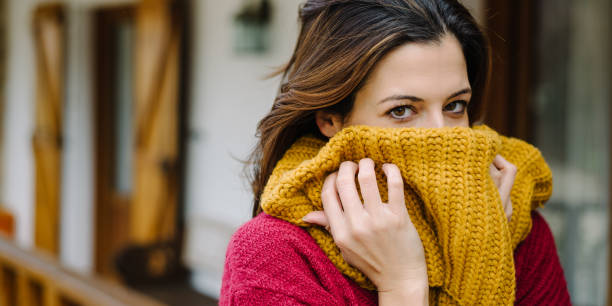 istock Young woman covering her face with scarf 1267164256