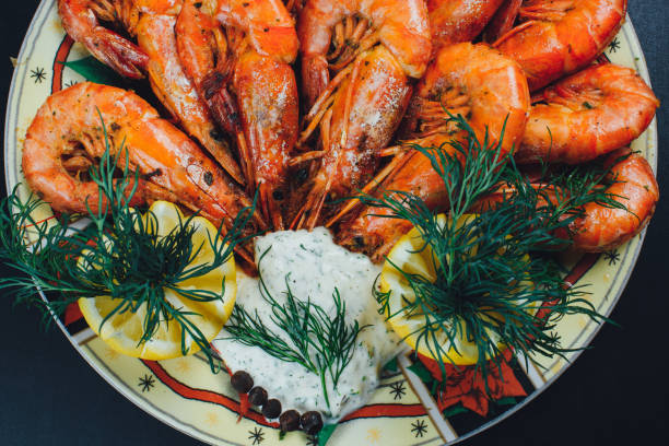 istock shrimps with lemon and black pepper on dark background 1267164472
