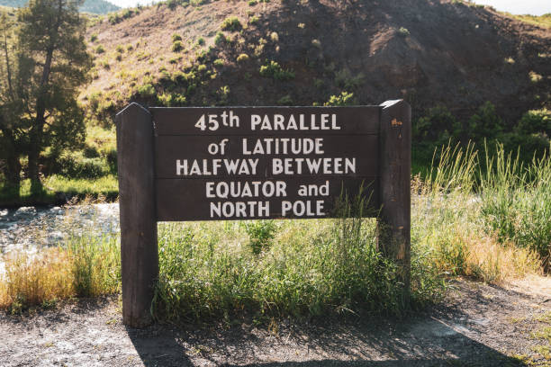 istock Sign - 45th Parallel of Latitude Halfway between Equator and North Pole sign in the North Entrance of Yellowstone National Park Wyoming 1267164594