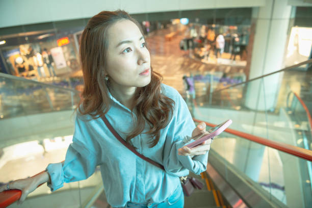 istock Woman using smartphone in the mall 1267165541