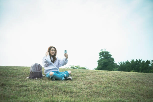 istock Beautiful asian woman in park 1267165559