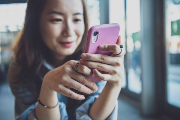 istock Woman using smartphone in coffee shop 1267165588