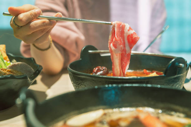 istock girl with hot pot and premium meat 1267165740