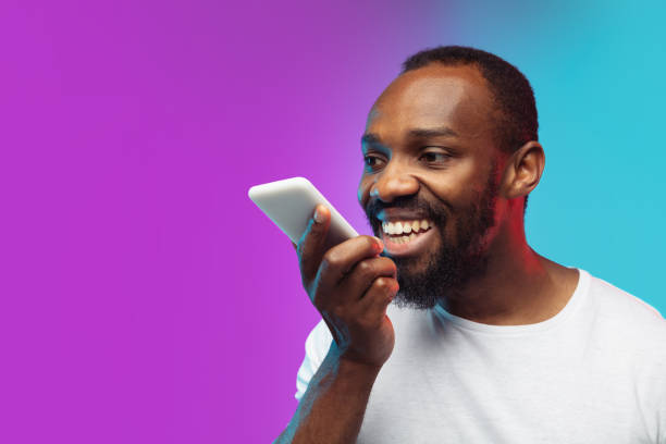 istock African-american young man's portrait on gradient studio background in neon 1267165806