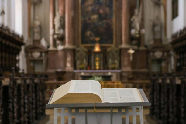 istock Bible or prayer book lying on praying bench in catholic church, selective focus 1267166073