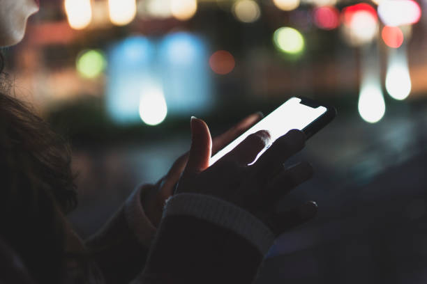 istock Woman hand using mobile phone in city 1267166733