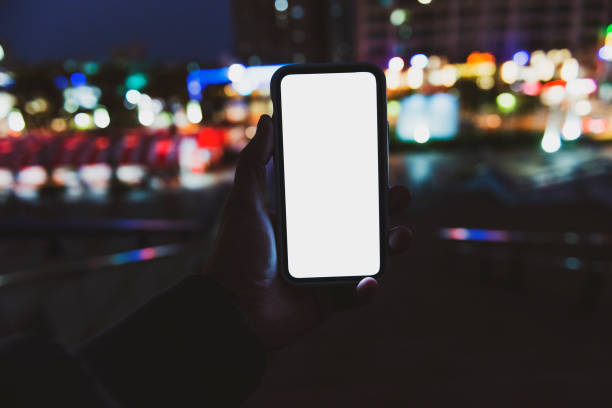 istock Woman hand using mobile phone in city 1267166747
