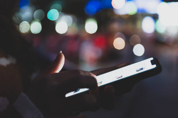 istock Woman hand using mobile phone in city 1267166775