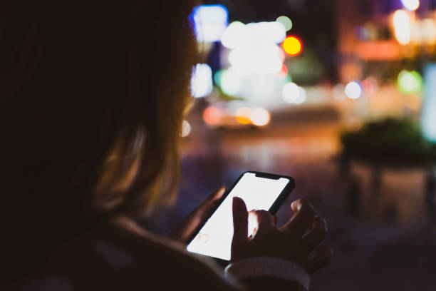 istock Woman hand using mobile phone in city 1267166815