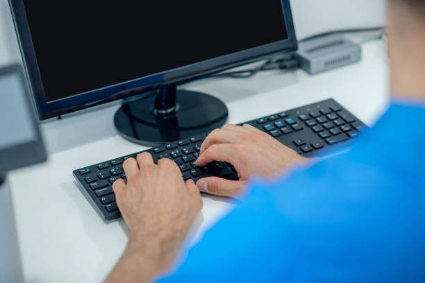 istock Male hands over black computer keyboard in office 1267167293