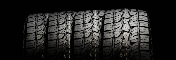 istock four tires in a row for SUVs and crossovers with powerful checkers and ground grabs close-up on a black background 1267167446