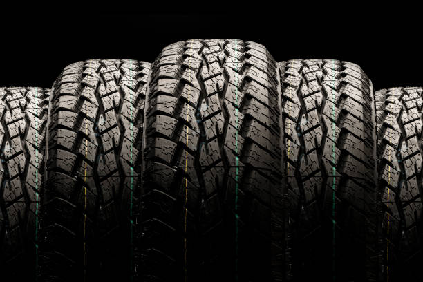istock Off-road tires close-up on a black background, displayed in a row 1267167549