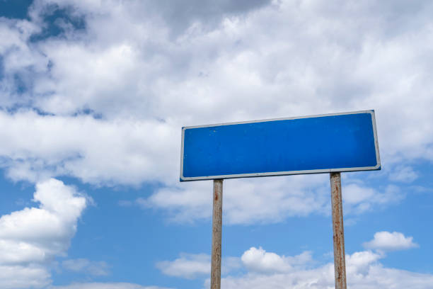 istock empty country road sign, a pointer on a background of blue cloudy sky 1267167783