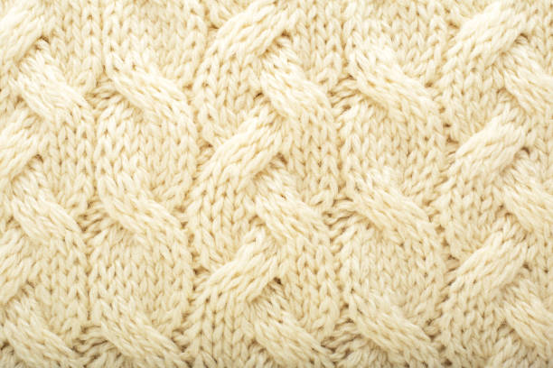 istock Beige knitted fabric wool texture for background. Close up of White Knitted material pattern for design. Beige warm sweater textile background. 1267168516