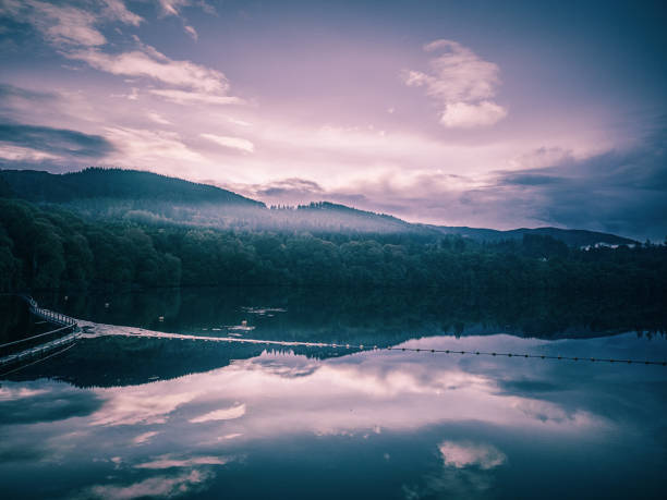 Idyllic Lake Tovel reflection, long exposure at sunrise – Trentino, Dolomites – Italy