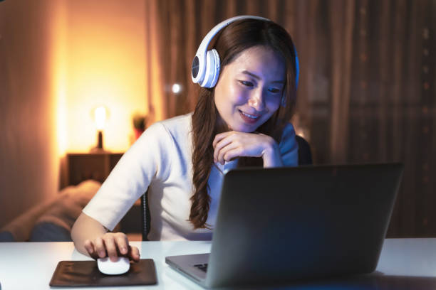 istock Asian woman working at home at night, using computer to learn online 1267169968