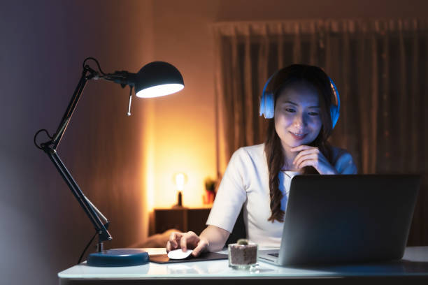 istock Asian woman working at home at night, using computer to learn online 1267169977