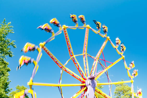 istock Extreme ride in motion in amusement park at sunny day 1267169997