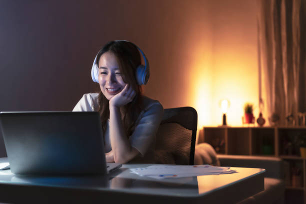 istock Asian woman working at home at night, using computer to learn online 1267170002