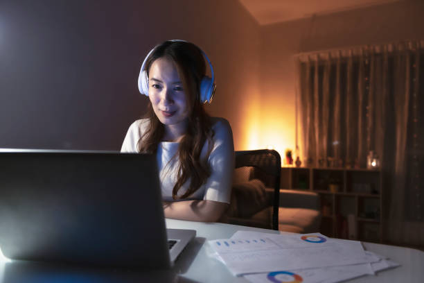 istock Asian woman working at home at night, using computer to learn online 1267170008