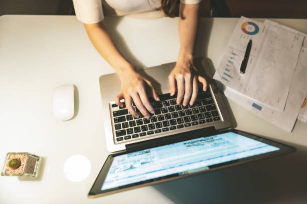 istock Asian woman working at home at night, using computer to learn online 1267170081