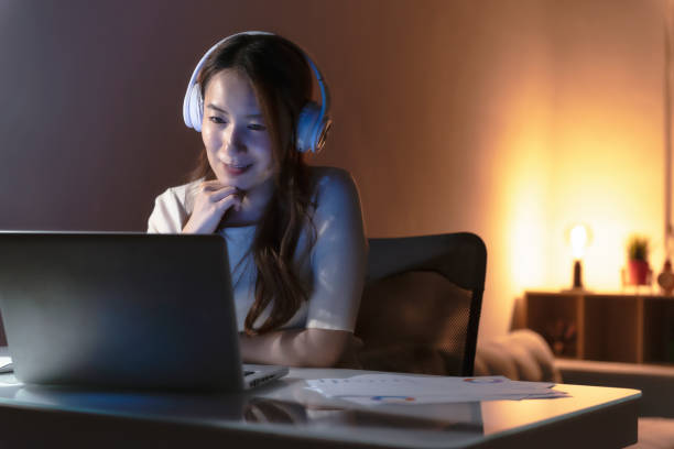 istock Asian woman working at home at night, using computer to learn online 1267170166