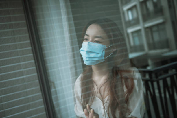 istock Woman wearing mask at home during isolation 1267170582