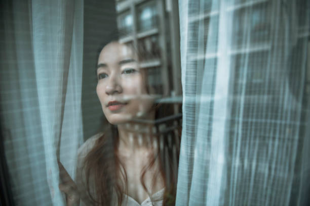 istock Woman at home through the glass 1267170589