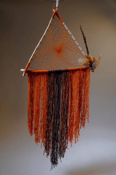 istock Handmade dreamcatcher with orange color triangle geometric shape 1267171834