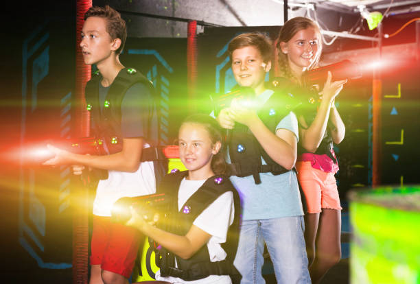 istock Happy teenagers with laser guns 1267172047