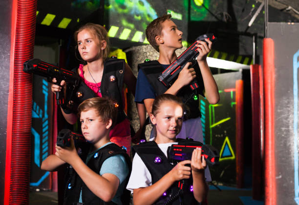 istock Happy teenagers with laser guns 1267172048