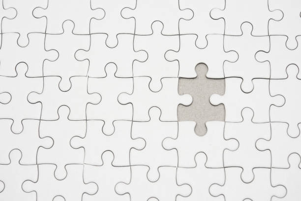 istock White jigsaw puzzle pattern background. placing last piece of jigsaw puzzle 1267172803