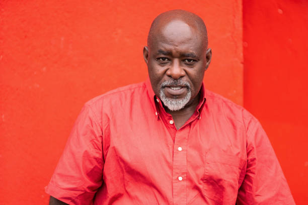 istock Mature afro man portrait on colorful red background 1267172843