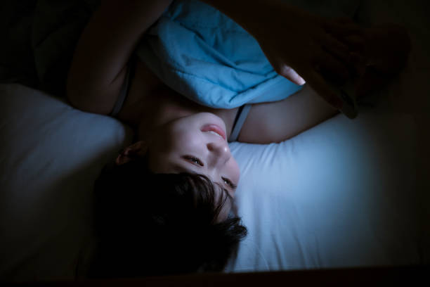 istock Woman Using Cellphone In Bed At Night 1267173269