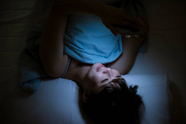 istock Woman Using Cellphone In Bed At Night 1267173345