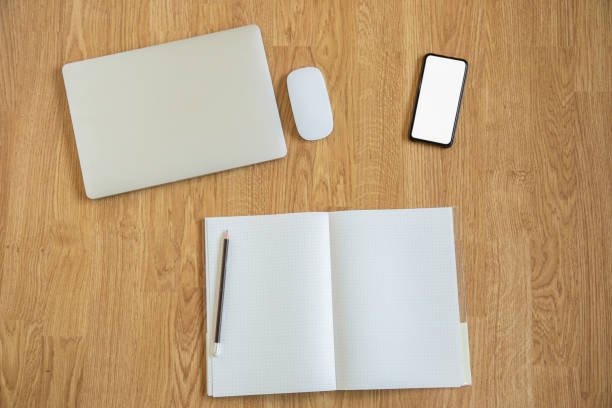 istock Top view shot of tools for working at home or anywhere in digital age which needs only smartphone, computer laptop, and book with pencil for connecting people around the world through wireless networking technology. 1267173689