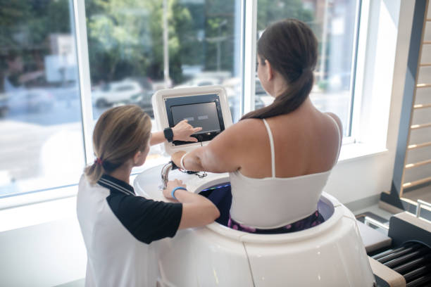 istock Trainer helping trainee to cope with a new treadmill 1267174471