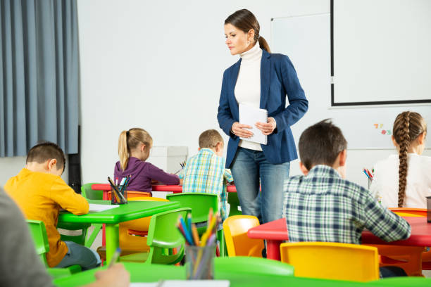 istock Teacher controlling work of school children 1267174792
