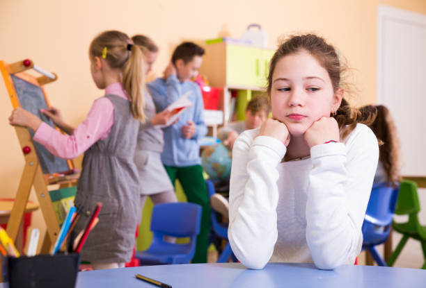 istock Sad bored schoolgirl in classroom at break 1267174848