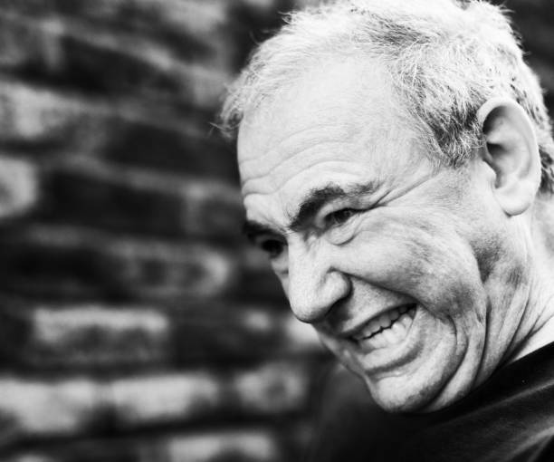 istock Furious senior man bares his teeth and grimaces 1267175720