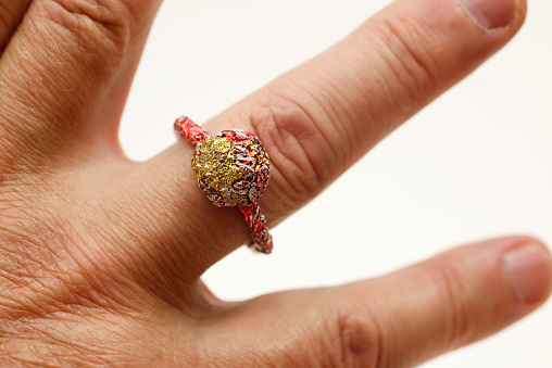 unpretentious finger ring made of recycled materials on the finger, the ring was made by the author of the photograph