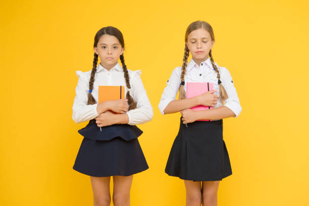 istock Education is step by step process of getting knowledge. Happy childhood. School education concept. Friends adorable pupils. Schoolgirls formal style school uniform. Classmates having fun at school 1267179177