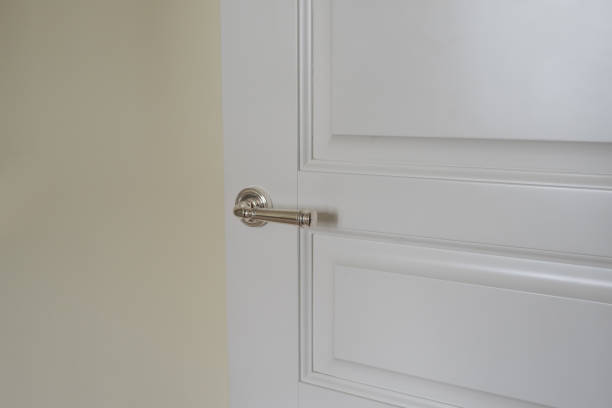istock White room door with the silver handle 1267180171