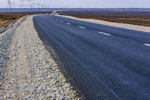 New asphalt road with white dividing strip