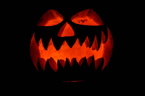 istock Spooky halloween pumpkin on a black background 1267181689
