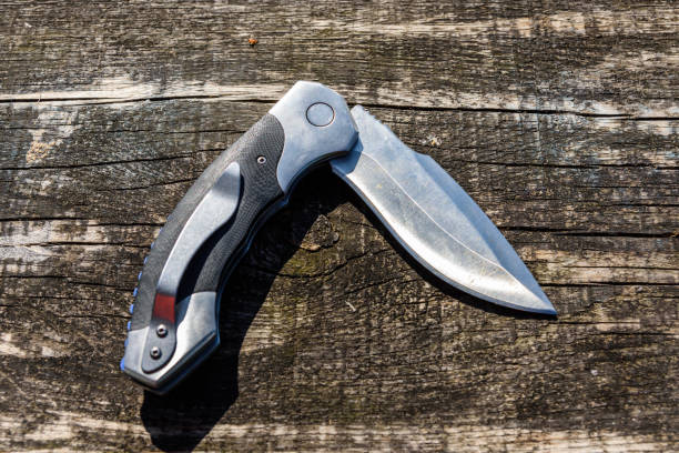 istock Folding knife on the rustic wooden background 1267182293