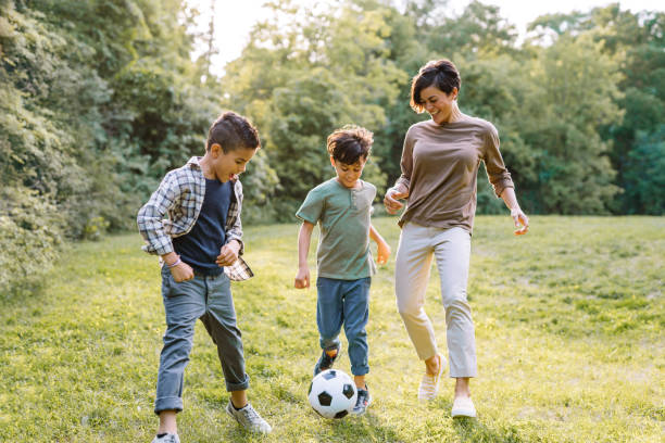 istock Mom playing soccer with sons 1267182510